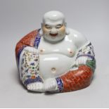 A Chinese famille rose figure of Budai, 23cm tall