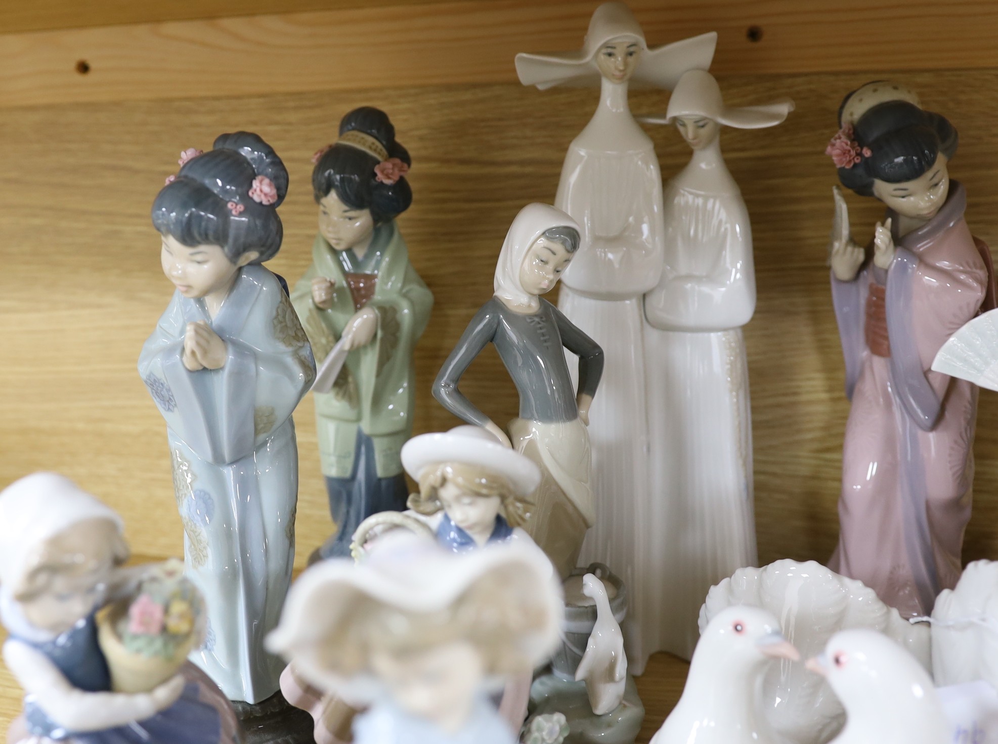 A selection of fifteen Lladro figures, tallest 35cm