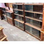 Five 1960's oak Minty bookcases comprising two four section, one three section, and a near pair of