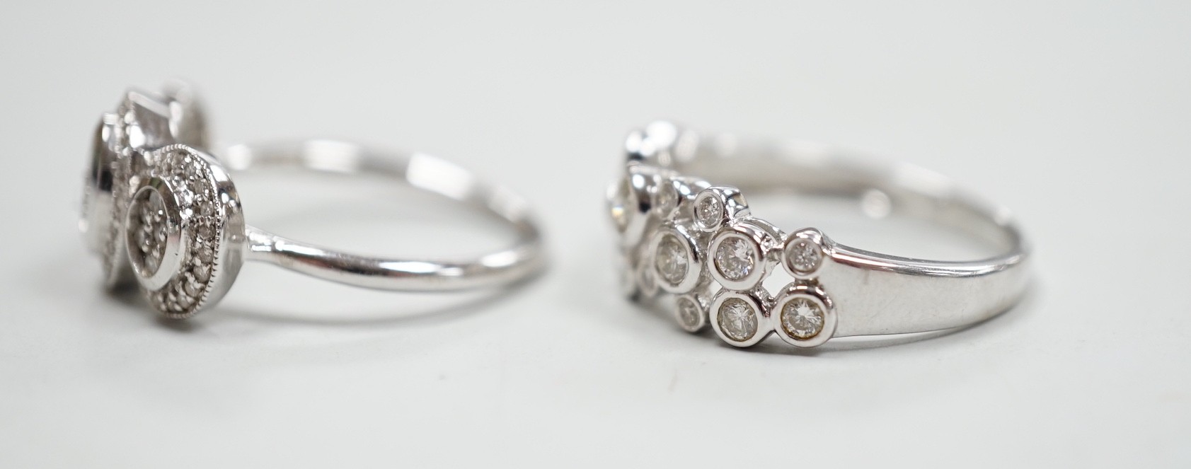 A modern 18ct white gold and diamond set triple cluster ring, size M and a similar 18ct white gold - Image 2 of 2