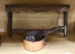 A set of five French copper saucepans, and a pendant from pine rack