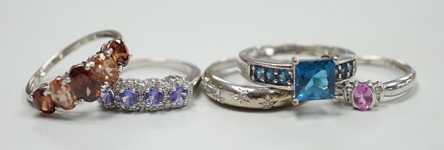 Five assorted modern 9ct white gold and gem set dress rings, including gypsy set diamond chip, gross