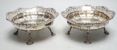 A pair of George VI pierced silver fruit bowls, on quadruped supports, with shell feet, James