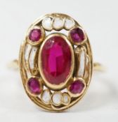 An 18ct, white enamel and four stone synthetic? ruby set oval dress ring, size N, gross weight 3.9