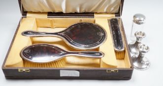 A George V cased three piece silver and tortoiseshell pique mounted mirror and brush set (lacking
