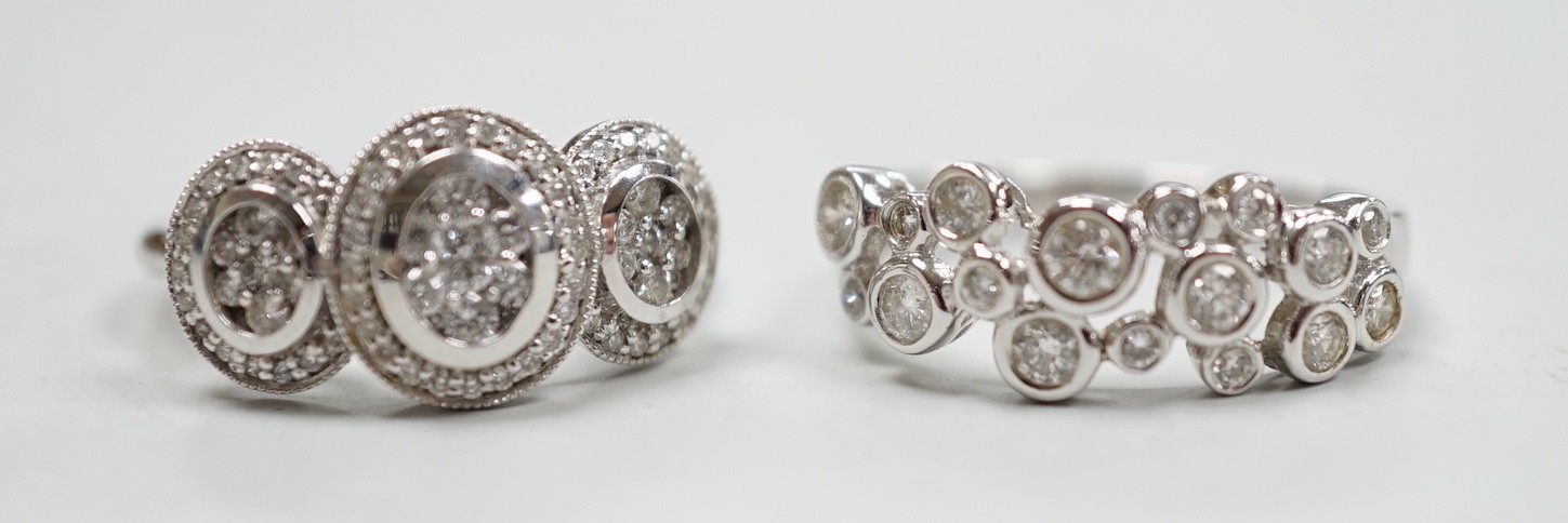 A modern 18ct white gold and diamond set triple cluster ring, size M and a similar 18ct white gold