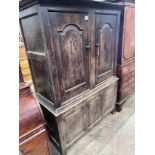 An early 18th century oak press cupboard two panelled doors and panelled base, width 127cm, depth
