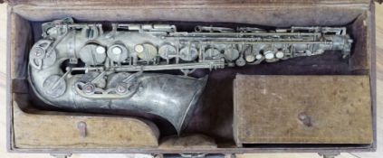 A cased saxophone marked ‘Lark, Shanghai, China M4021’