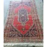 Two antique North West Persian red ground rugs, (worn) larger 183 x 125cm *Please note the sale