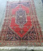 Two antique North West Persian red ground rugs, (worn) larger 183 x 125cm *Please note the sale