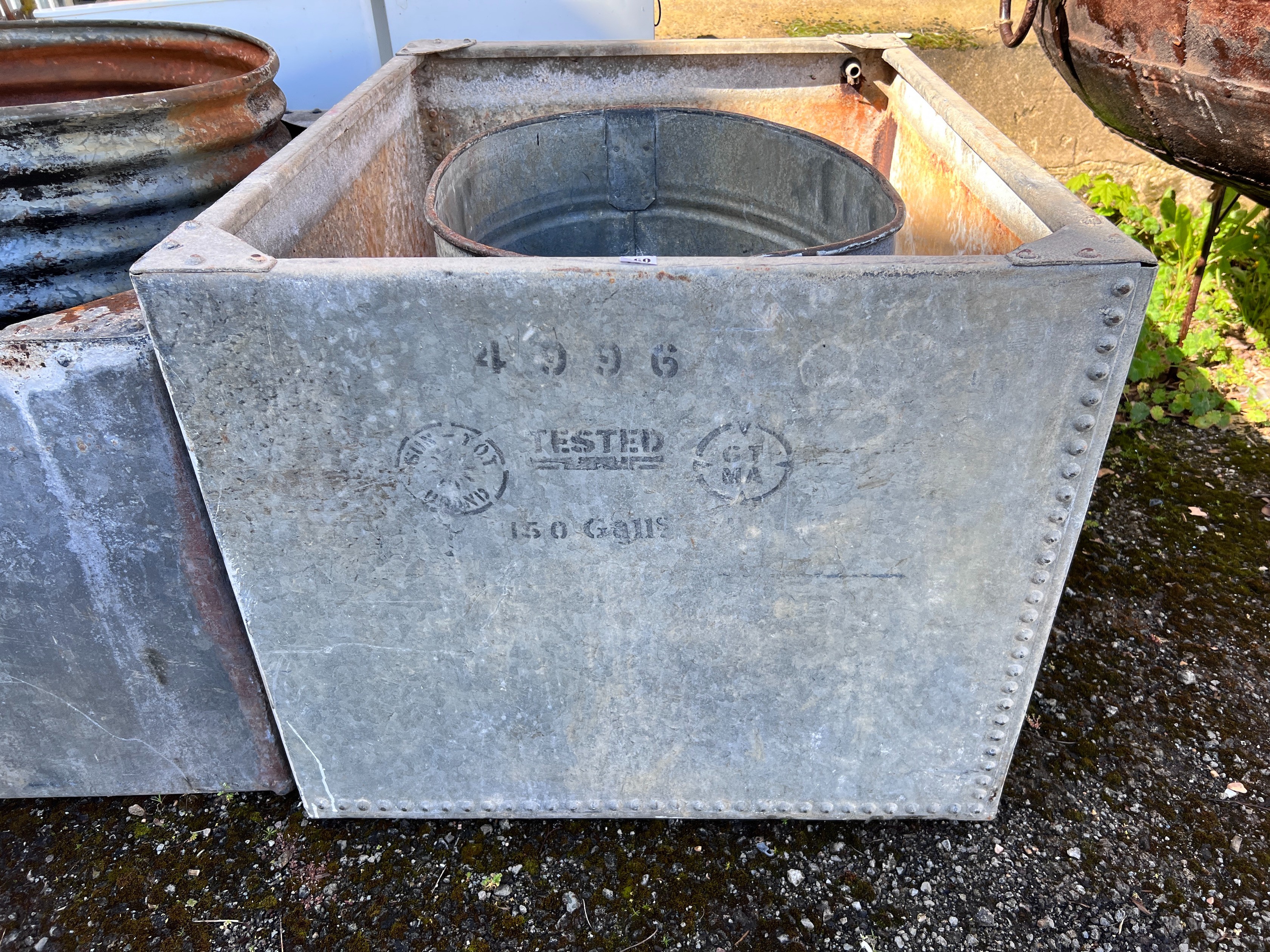 A large rectangular galvanised tank, width 107cm, depth 84cm, height 72cm together with an oval