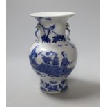 A small Chinese twin handled blue and white porcelain vase, Kangxi marks to underside, 19th century,