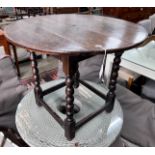 A circular oak bobbin legged table, diameter 73cm, height 61cm *Please note the sale commences at