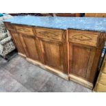 A continental marble topped fruitwood breakfront bookcase, with variegated grey marble top, four