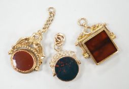 Two early 20th century 9ct gold and chalcedony set spinning fobs and one other yellow metal and