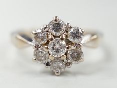 A modern 18ct white gold and seven stone diamond set hexagonal cluster ring, size O, gross weight
