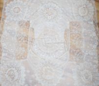 A late 19th century Normandy lace table cover of hand spun linen, hand white worked, with Brussels