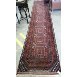 A Belouch red ground runner, approx. 400 x 84cm *Please note the sale commences at 9am.