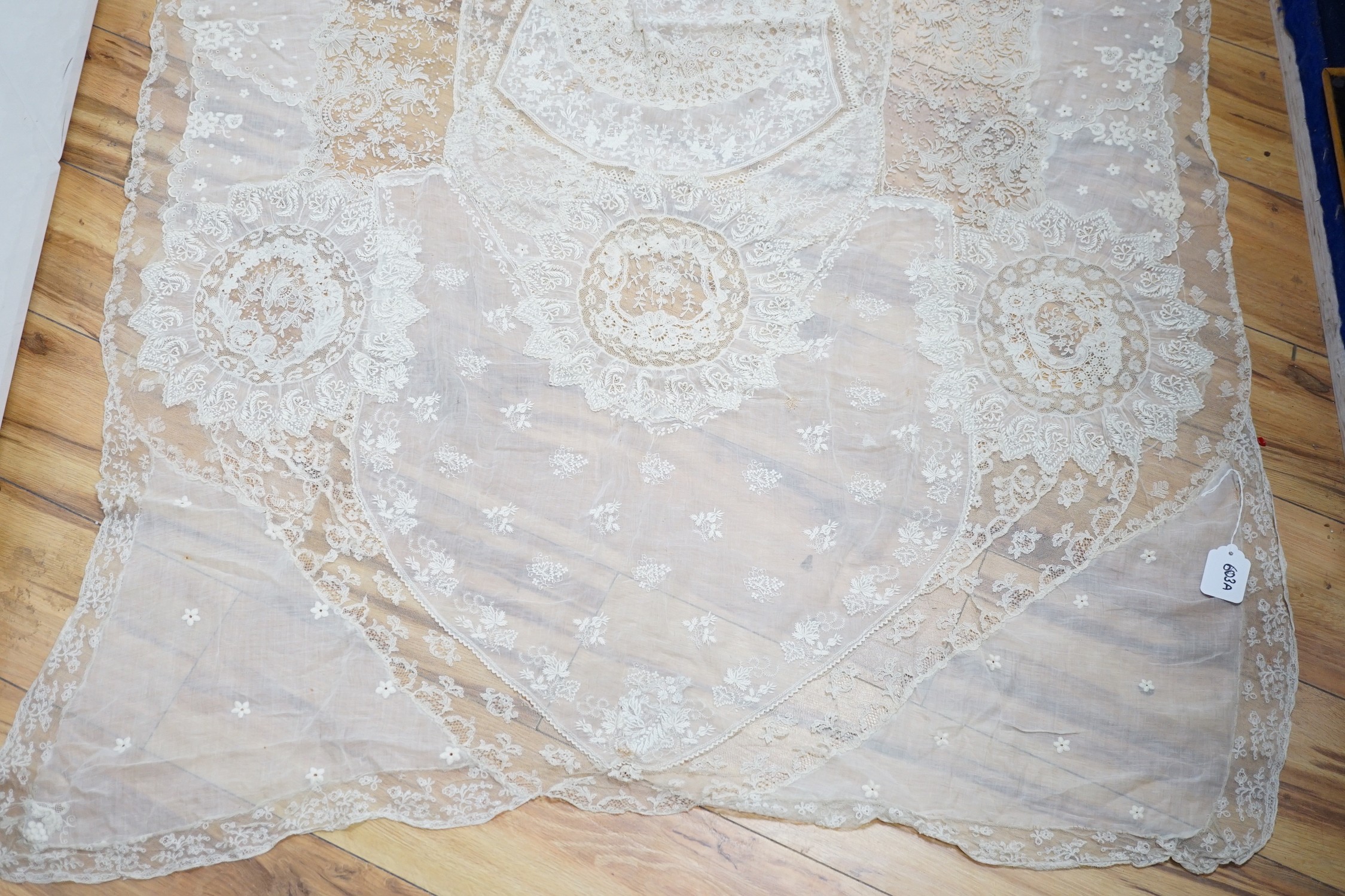 A late 19th century Normandy lace table cover of hand spun linen, hand white worked, with Brussels - Image 2 of 2