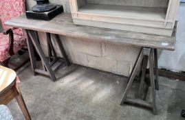 A Victorian style trestle table with planked top, length 175cm, width 49cm, height 82cm *Please note