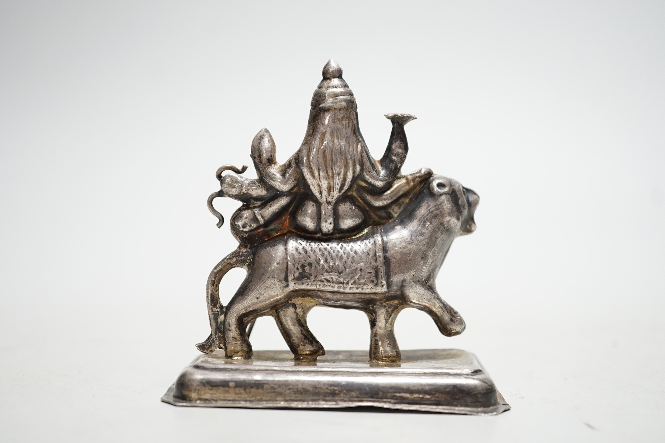 A Buddhist white metal group of a Bodhisattva riding a lion, 8cm tall - Image 2 of 2