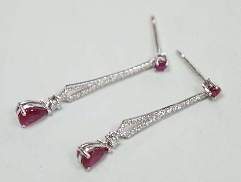 A modern pair of 18k white metal, ruby and diamond cluster set line drop earrings, 30mm, gross