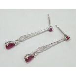 A modern pair of 18k white metal, ruby and diamond cluster set line drop earrings, 30mm, gross
