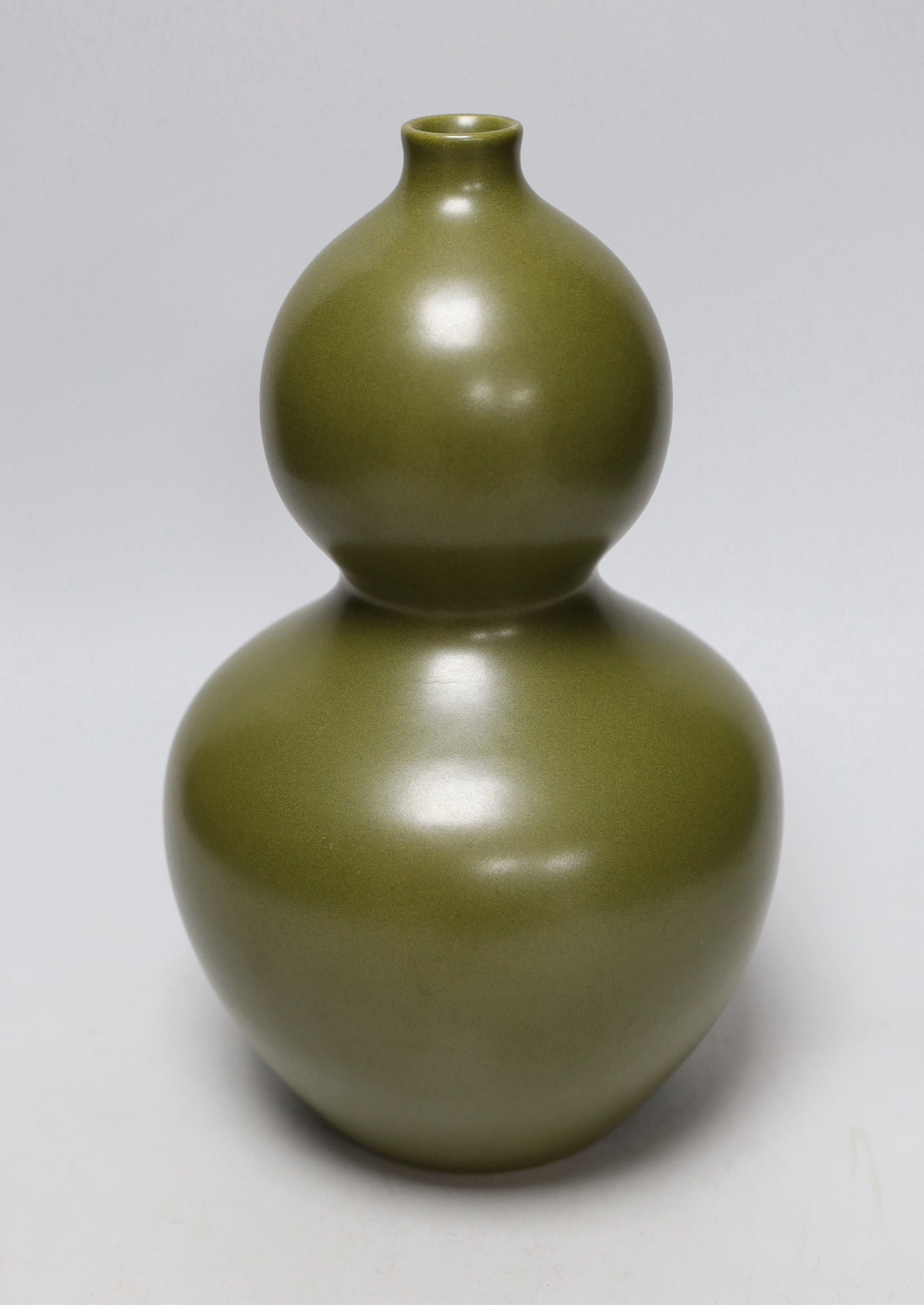 A Chinese olive green double gourd vase, 29cm high