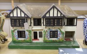 A Tri-Ang mock Tudor style doll's house and furnishings, 68cms wide, 42cms high