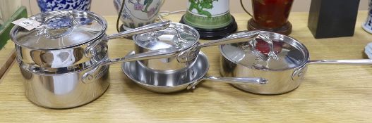 An “All Clad”, stainless steel steamer saucepan and cover, two other saucepans and covers and a
