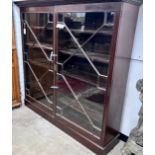 A George III mahogany two door bookcase, adapted, width 164cm, depth 40cm, height 159cm*Please
