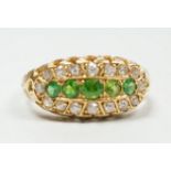 An Edwardian 18ct gold, demantoid garnet and diamond set oval cluster half hoop ring, size L,