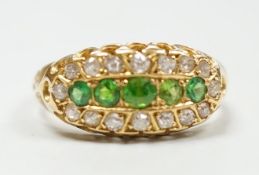 An Edwardian 18ct gold, demantoid garnet and diamond set oval cluster half hoop ring, size L,
