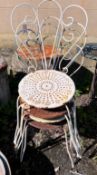 A circular wrought iron garden table and four chairs, diameter 50cm, height 80cm *Please note the