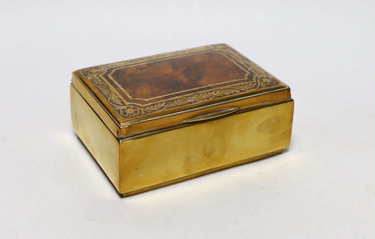 A burr oak topped brasswork cigarette box, 14ms wide x10cms deep