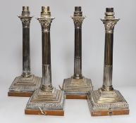 A set of four early 20th century silver plated Corinthian column table lamps on marble stands