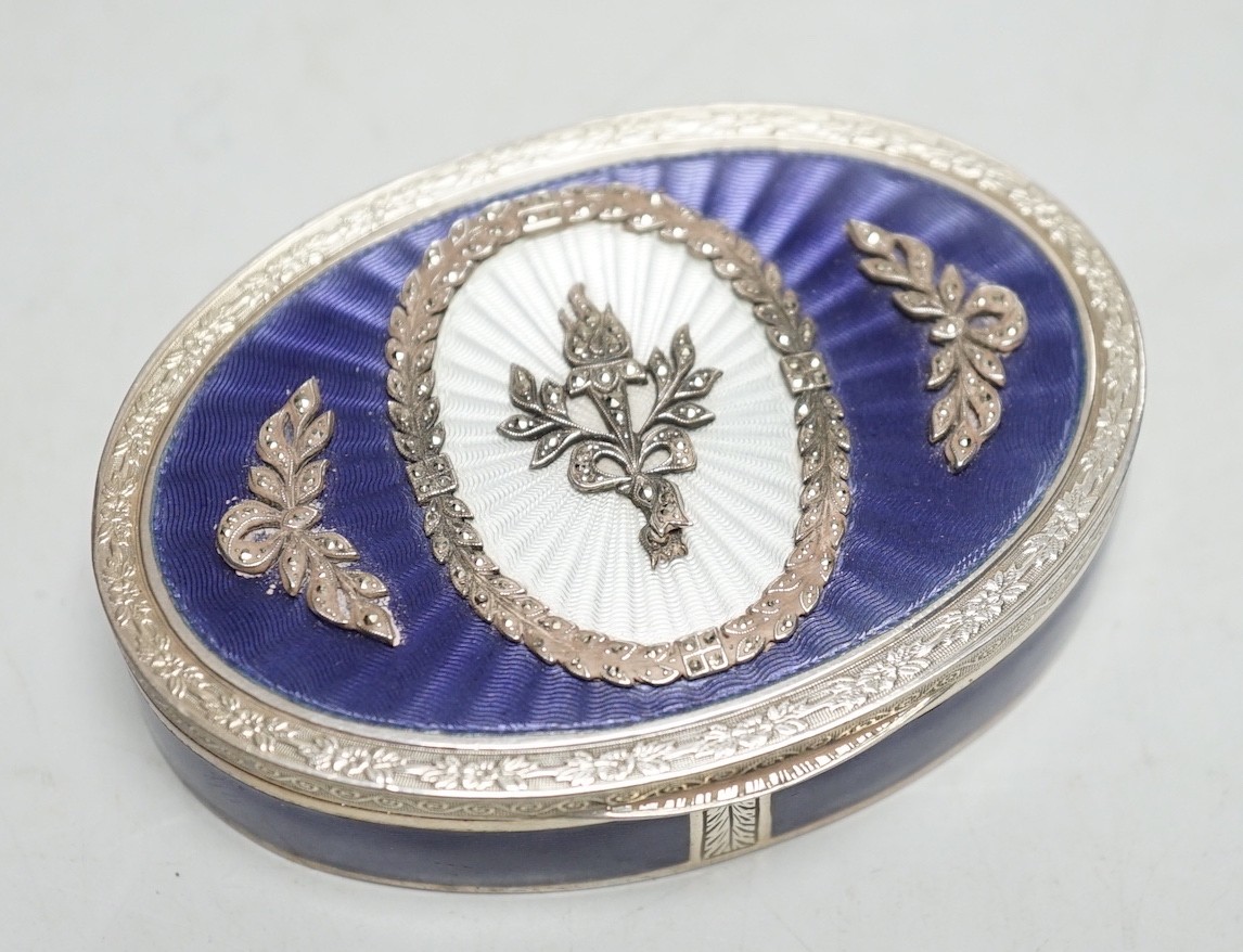 A 1920's continental 835 standard white metal, enamel and marcasite set oval box, 69mm.