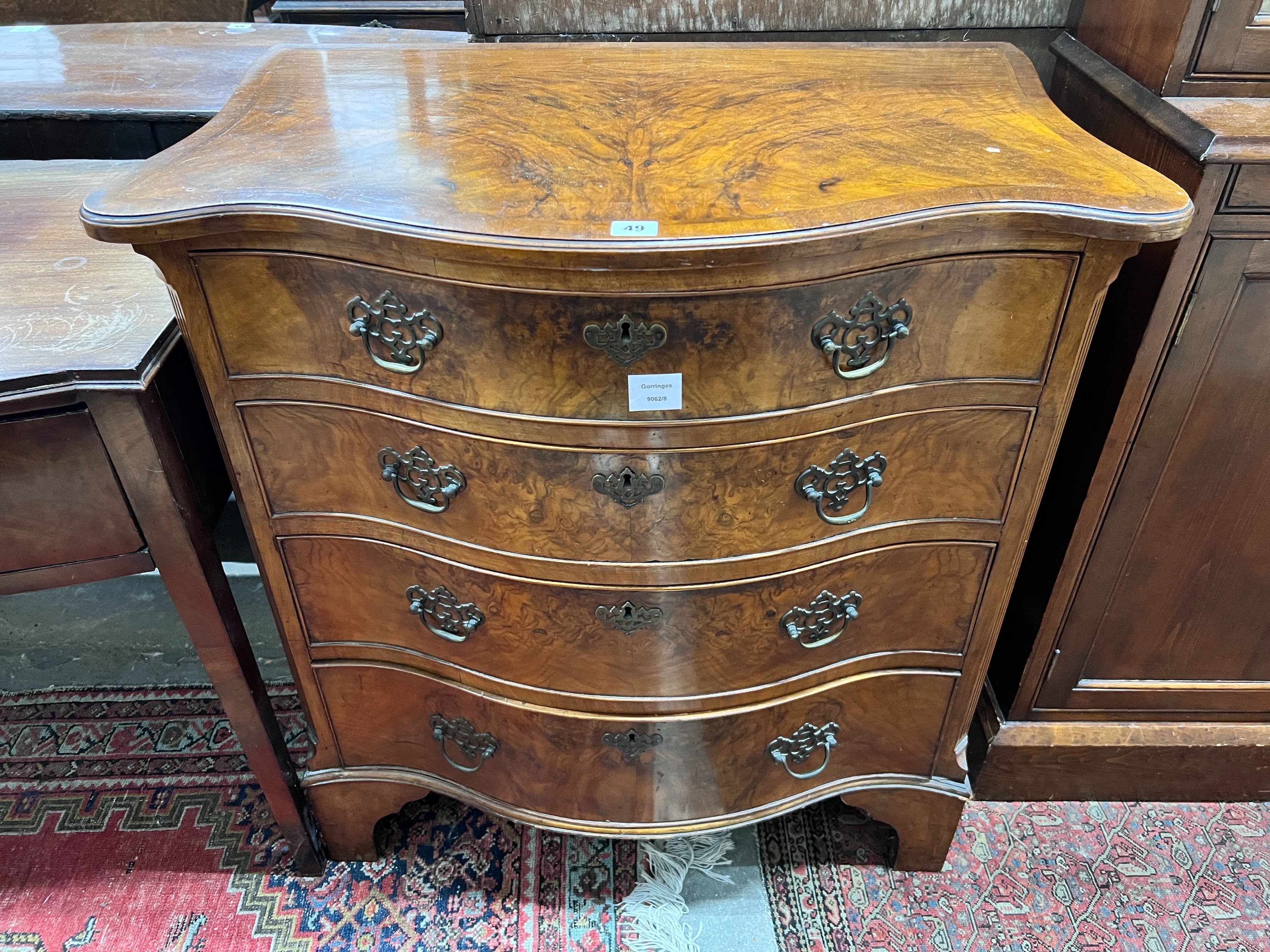 A George III style walnut serpentine fronted chest, fitted four long graduated drawers, width