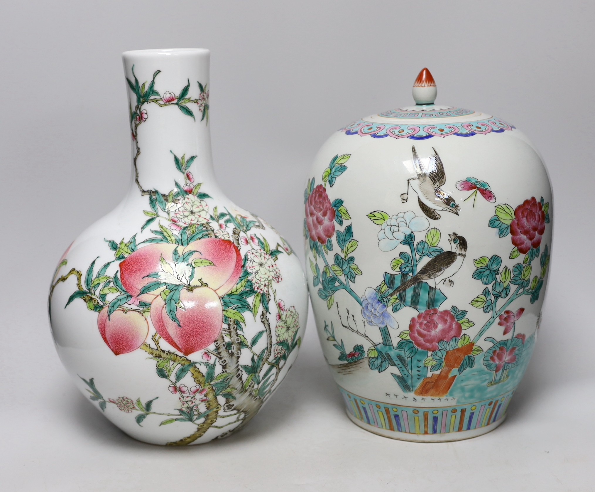 A Chinese vase with cover, with a peach and bat bottle vase, tallest 35cm high