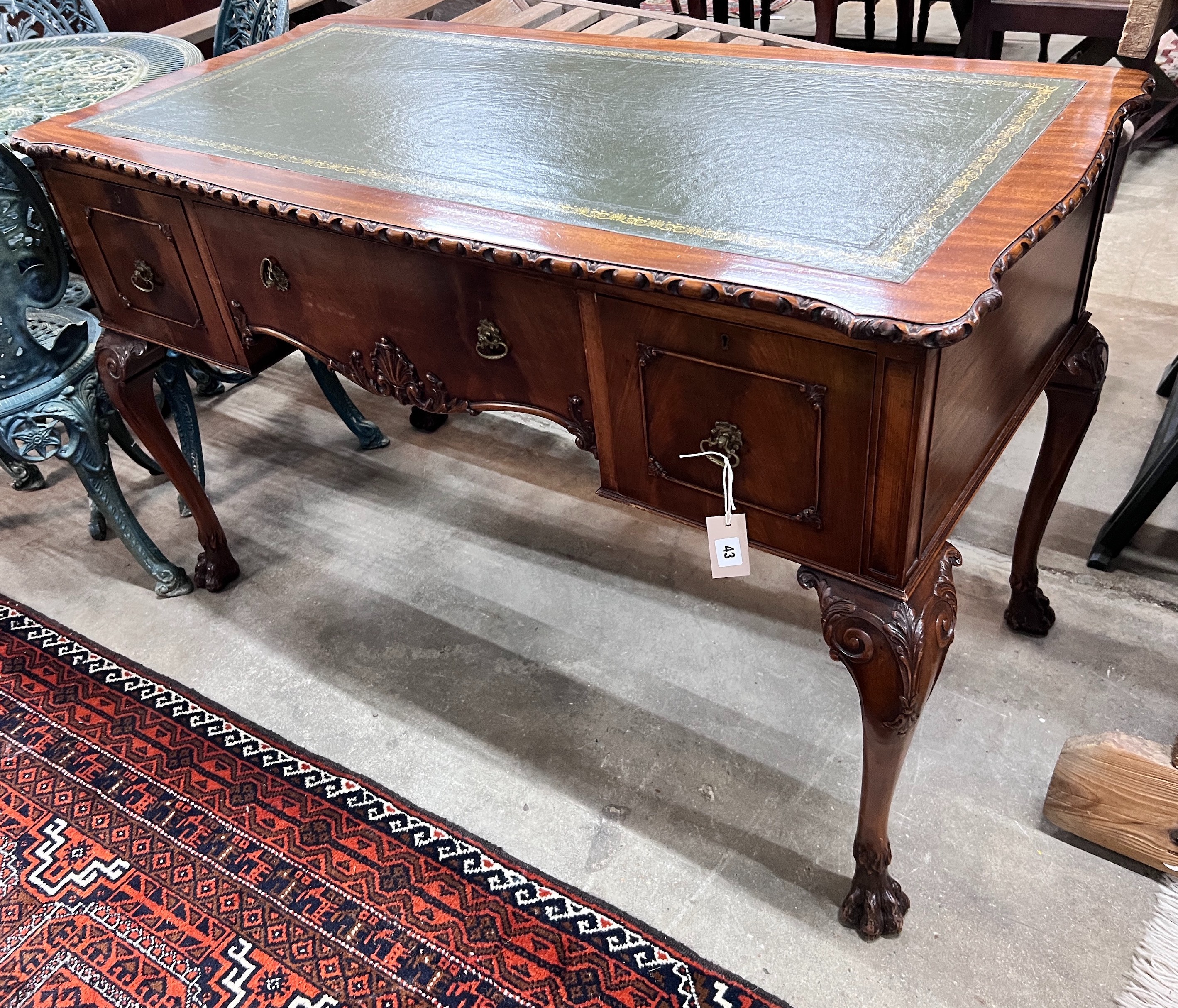 A reproduction George III style mahogany kneehole writing table, width 120cm, depth 58cm, height