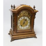 A walnut ting tang mantel clock, 34cms high