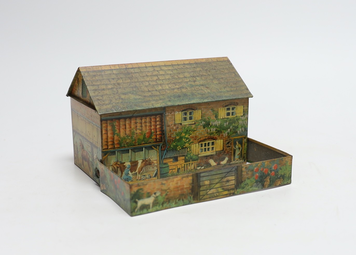 Britains farm series, a Schuco type monkey and a Huntley & Palmers novelty farmhouse biscuit tin,