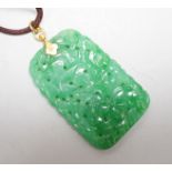 A carved Chinese jadeite pendant with pierced decoration. 5.5 x 3cm