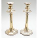 A pair of George V silver mounted candlesticks, with panelled stems, by James Dixon & Sons,