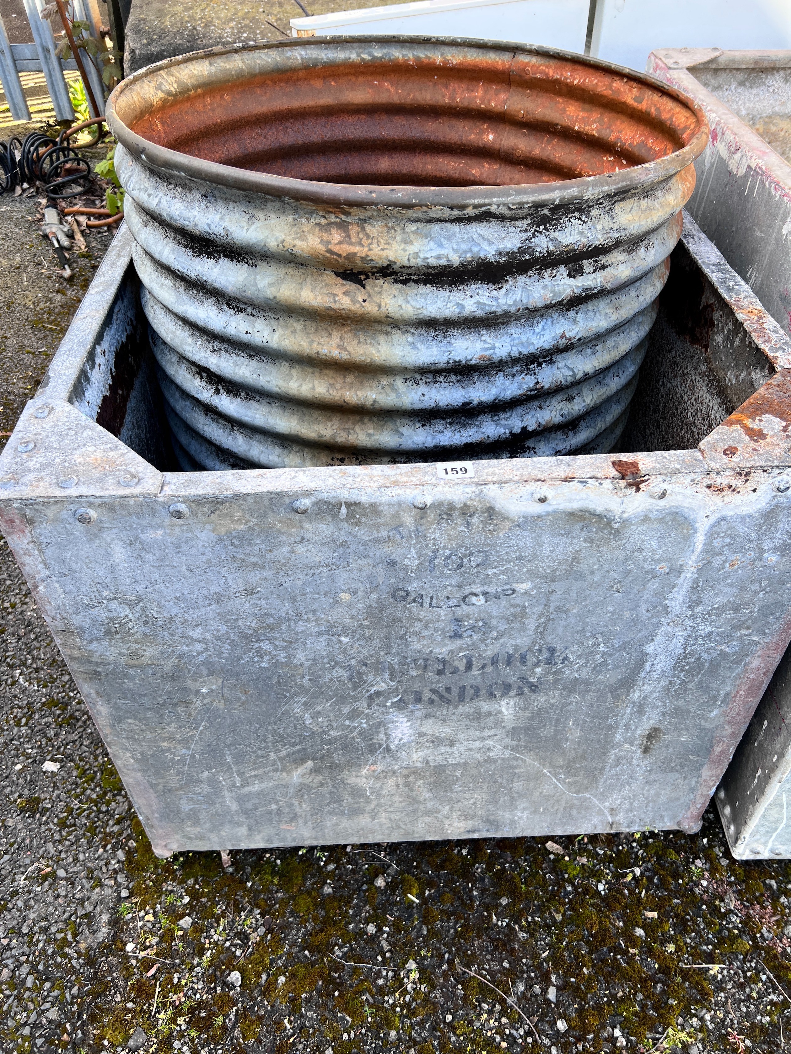 A large rectangular galvanised tank, width 90cm, depth 76cm, height 64cm together with a circular