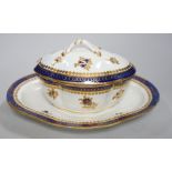 An 18th century Caughley tureen cover and stand with blue and gilt decoration, stand mis-fired to