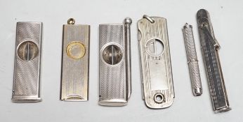 Two silver cigar cutters, a plated tamper and two other cutters / piercers