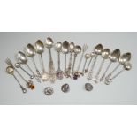 A collection of small silver and white metal spoons and forks including commemorative and three