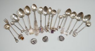 A collection of small silver and white metal spoons and forks including commemorative and three