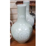 A pair of Chinese white slip decorated celadon glazed bottle vases, mid 20th century, 39cm